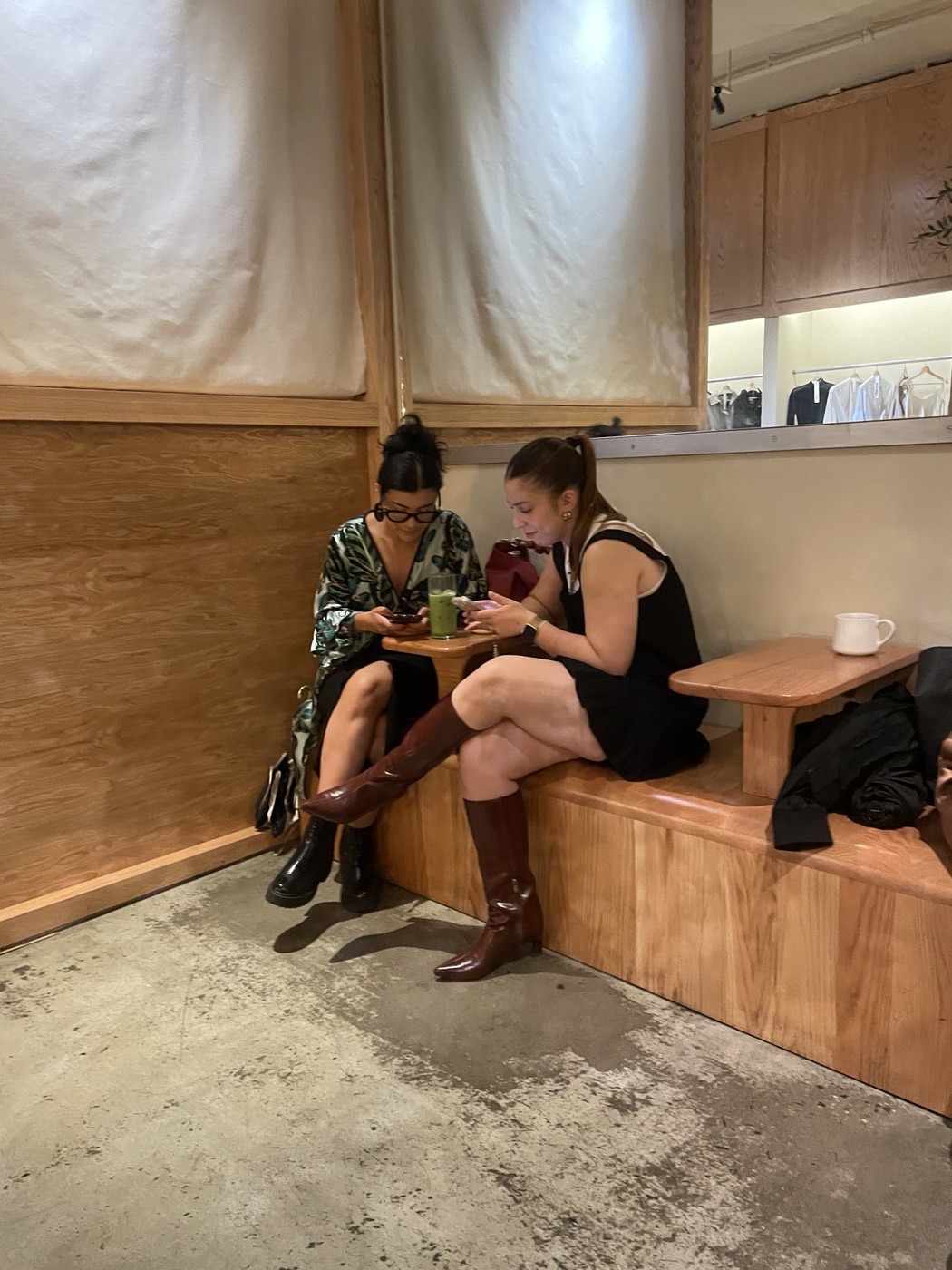 Guests exploring HangRr on their phones over matcha at Manjul Coffee & Clothing