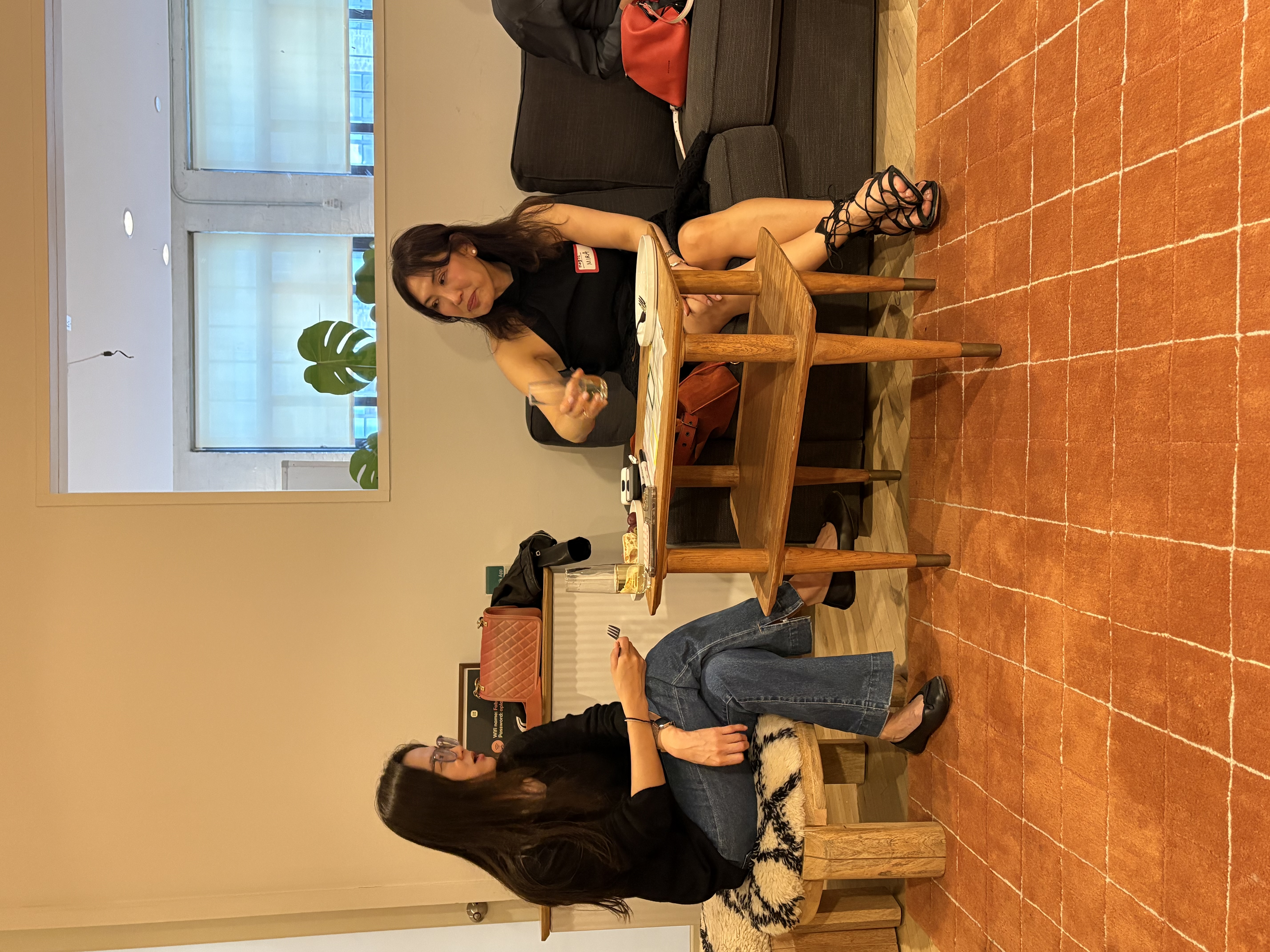 Two attendees chatting on sofas