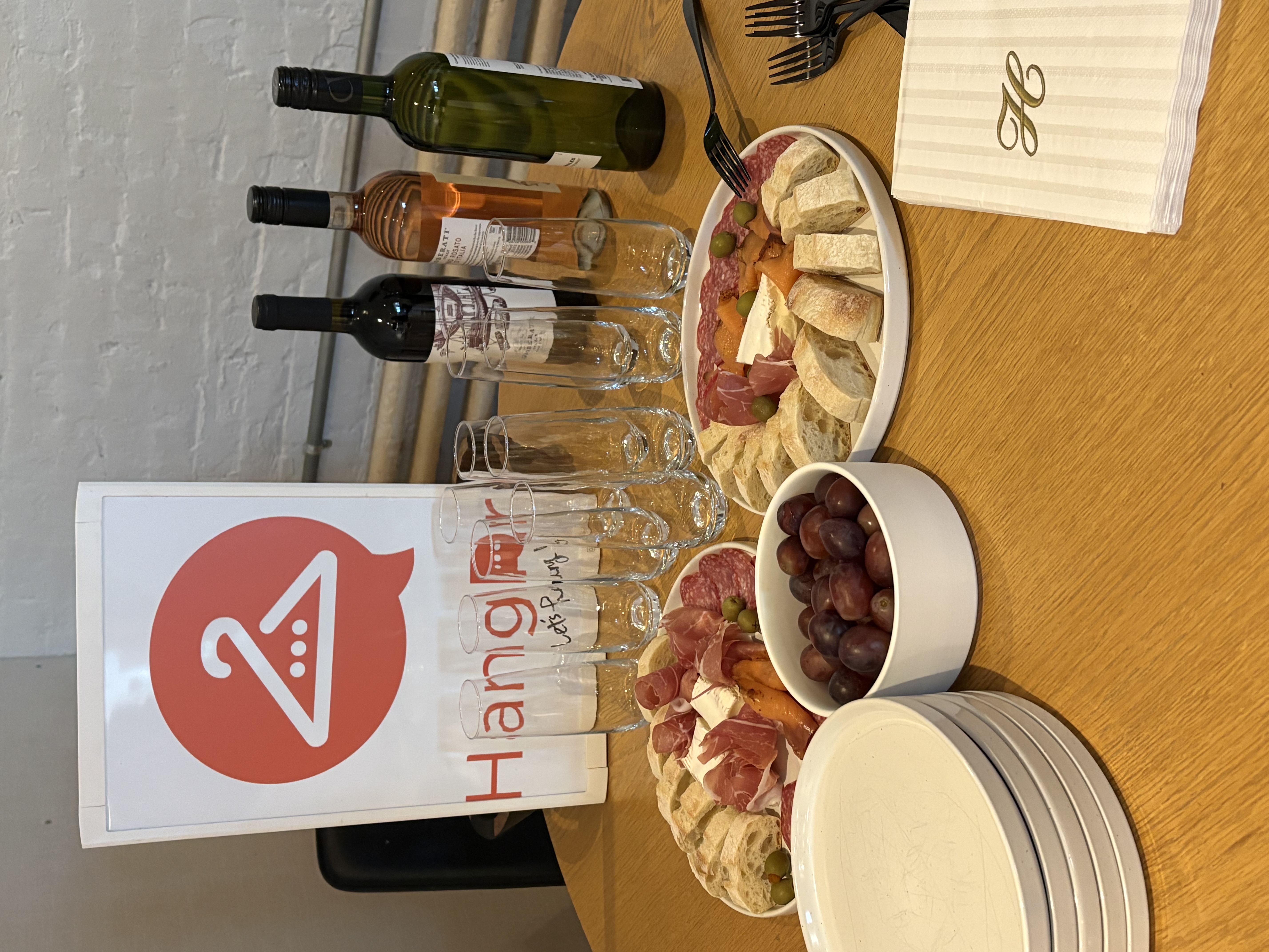 HangRr sign with wine and charcuterie spread